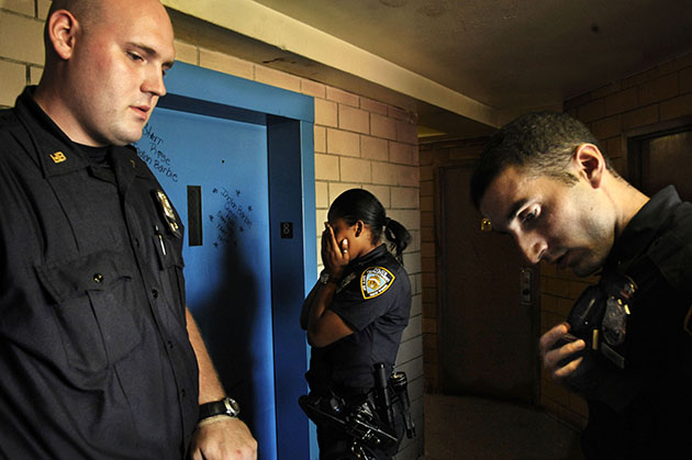 Three officers listen to a colleague ask for urgent assistance over the radio&mdash;without a patrol car, they have no way to respond.