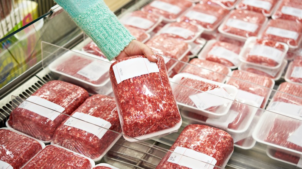 Buyer woman chooses chopped meat in shop