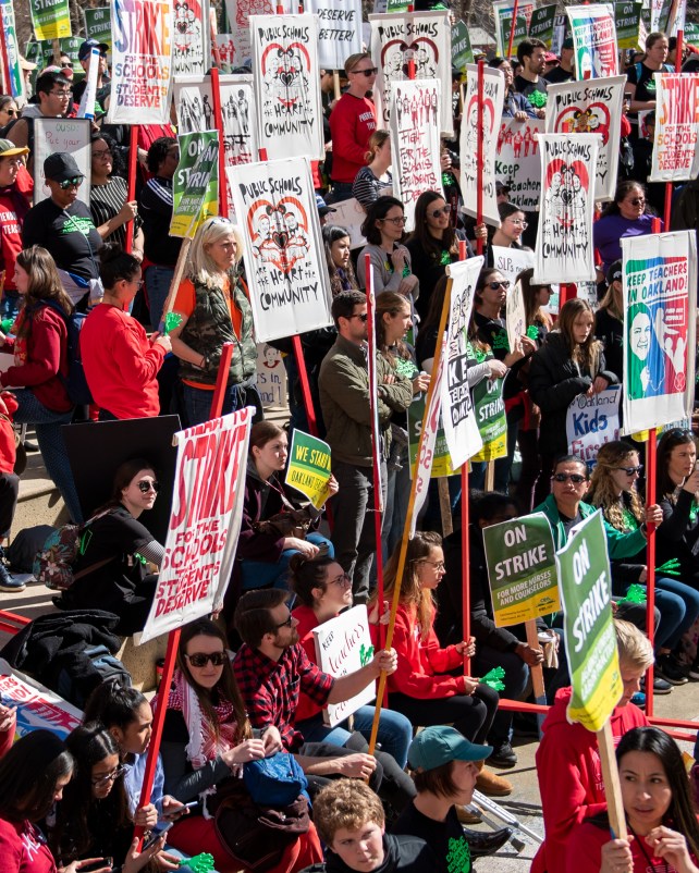 Hundreds of teachers, students, and supporters rally in downtown Oakland, Calif., on the first day of a district-wide teacher strike.
