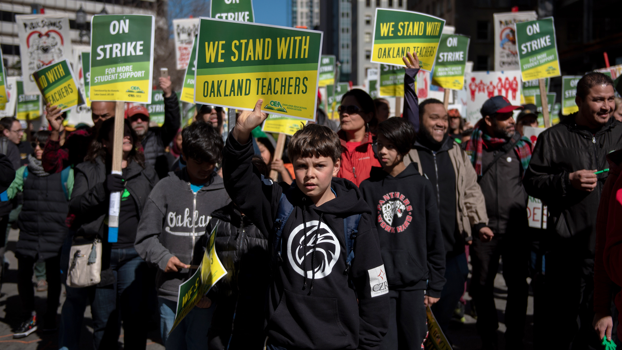 On the first day of a district-wide strike, students joined their teachers in Oakland, Calif., to demand higher wages for educators and more resources for public schools. Gabe, 10, holds a sign during the march in downtown Oakland.