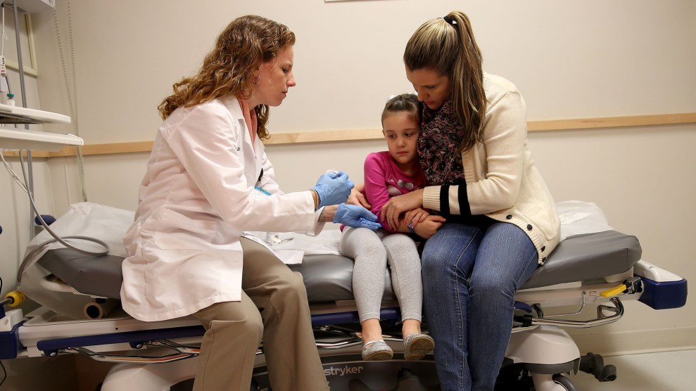 Pediatrician Dr. Amanda Porro prepares to administer a measles vaccination to Sophie Barquin, 4, as her mother holds her during a visit to the Miami Children's Hospital on January 28, 2015.