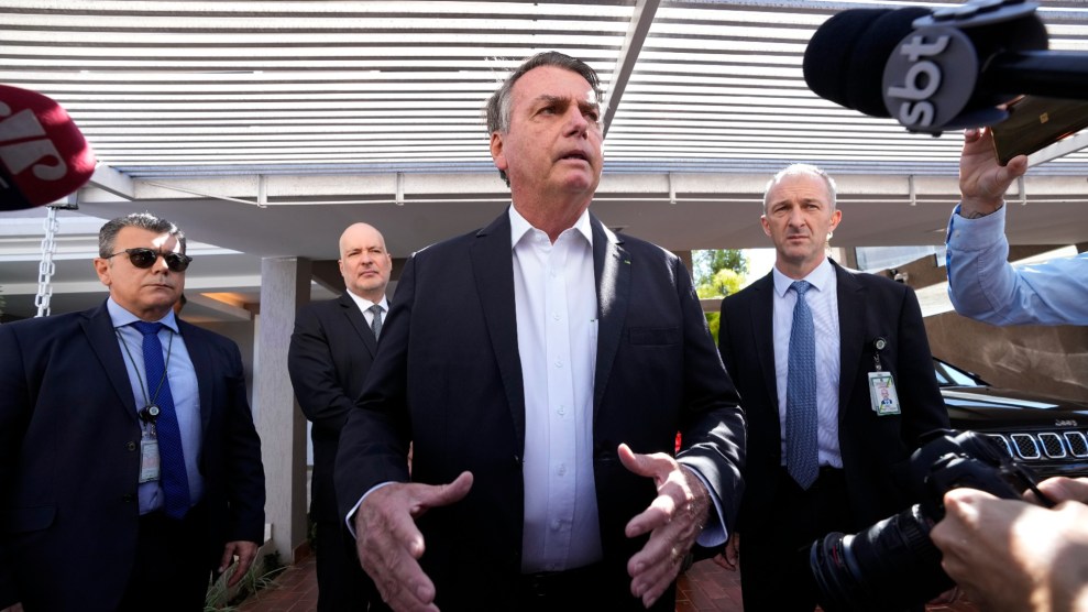Former Brazilian President Jair Bolsonaro speaks to the press outside his home.