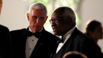 Mike Pence and Clarence Thomas talk to each other while wearing tuxedos.