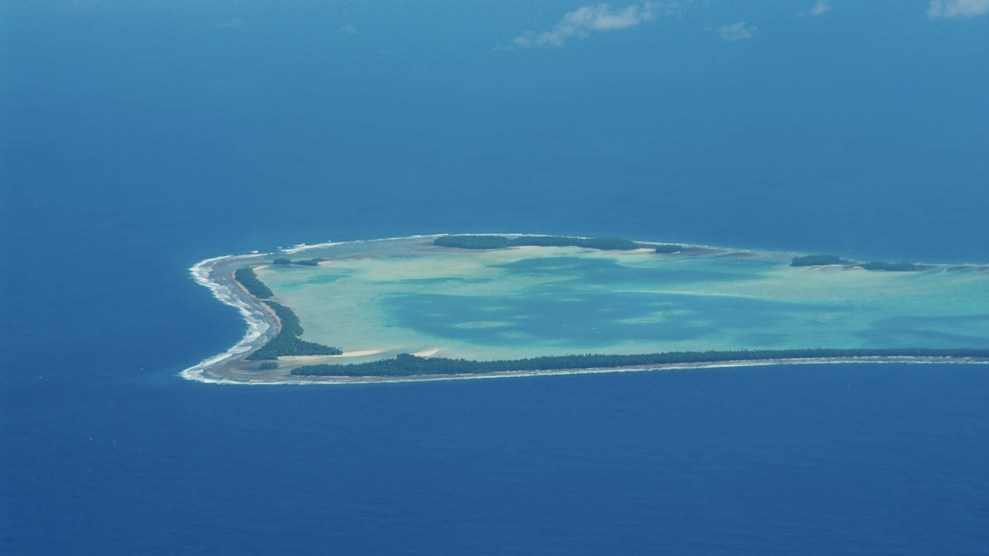 An aerial view of part of the small island Tuvalu, which is surrounded by blue ocean water