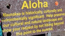 Sign that says, "Aloha. Maunakea is historically, culturally and environmentally significant. Help preserve our cultural and natural landscape and show your respect by not hiking beyond this point to the summit."
