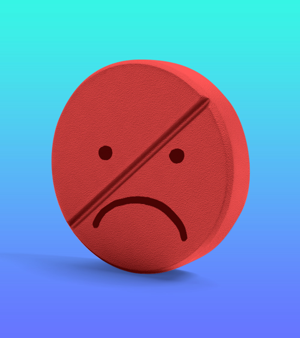An illustration of a red pill with a sad face drawn on it.