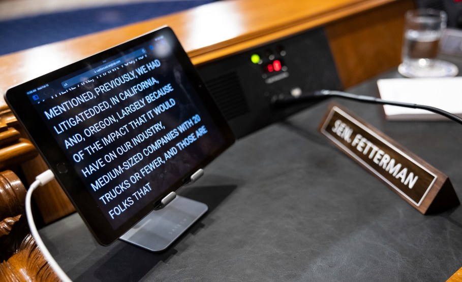 A tablet on Sen. Fetterman's desk that says "mentioned previously, we had litigated in California and Oregon, largely because of the impact that it would have on our industry, medium-sized companies with 20 trucks or fewer."