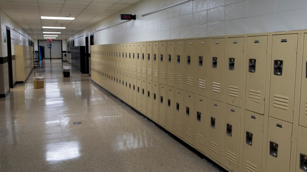 An empty hallway with yellow lockers