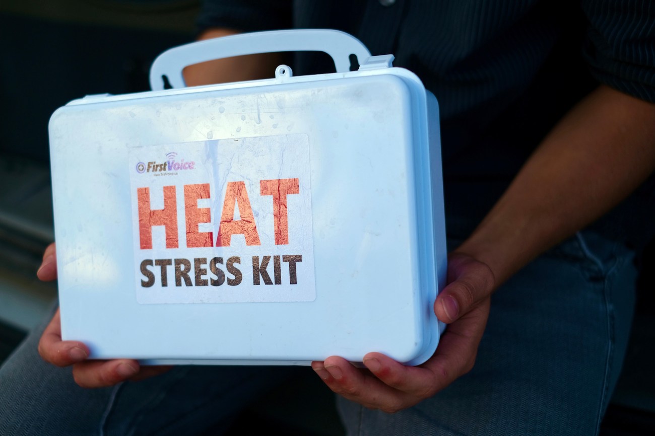 person holding a heat stress kit