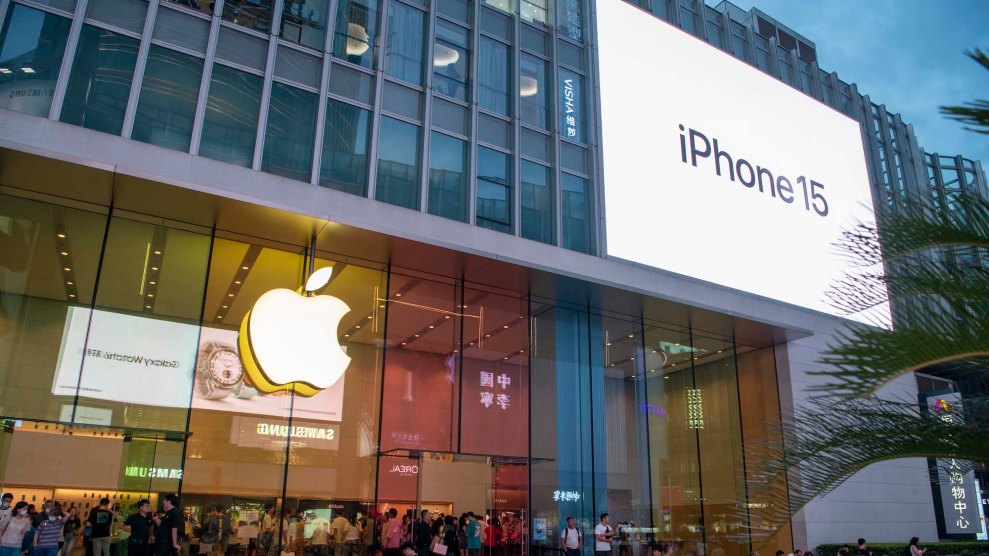 The front of an Apple store, which has an Apple logo and a screen that says "iPhone15"