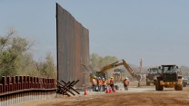 The border wall with a crew working on it