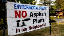 A banner that says, "Environmental Justice. No Asphalt Plant in Our Neighborhood"