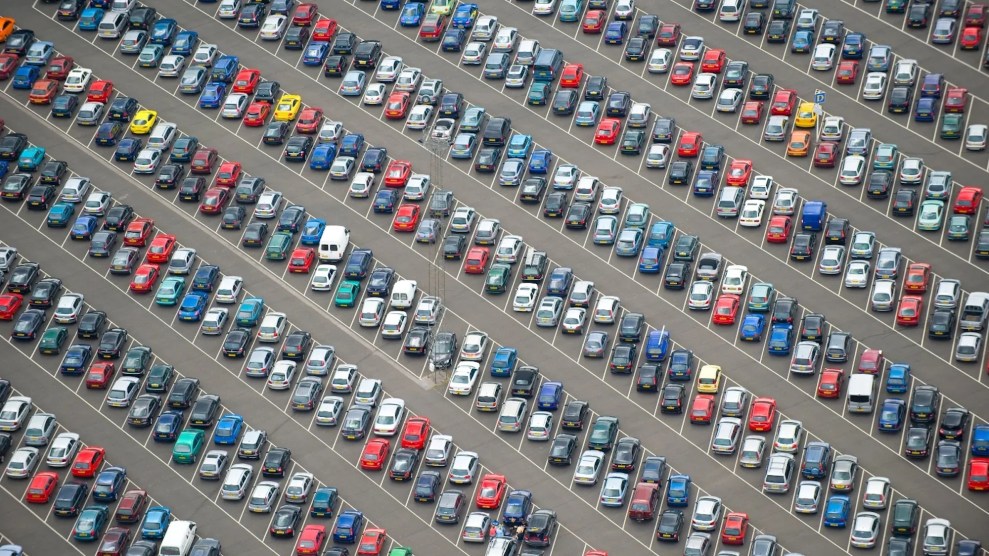 A parking lot that seems to have hundreds of cars in it