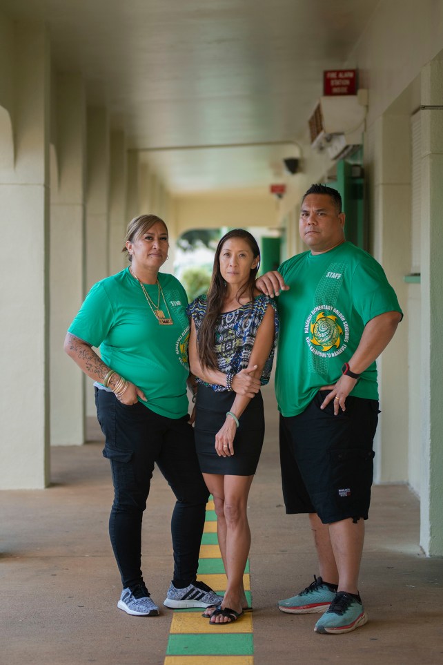 Portrait of Dr Christina Keaulana and Education Assistants Maria Manandic and David DeMotto at Nanakuli Elementary School. The three stand next to each other, outside.
