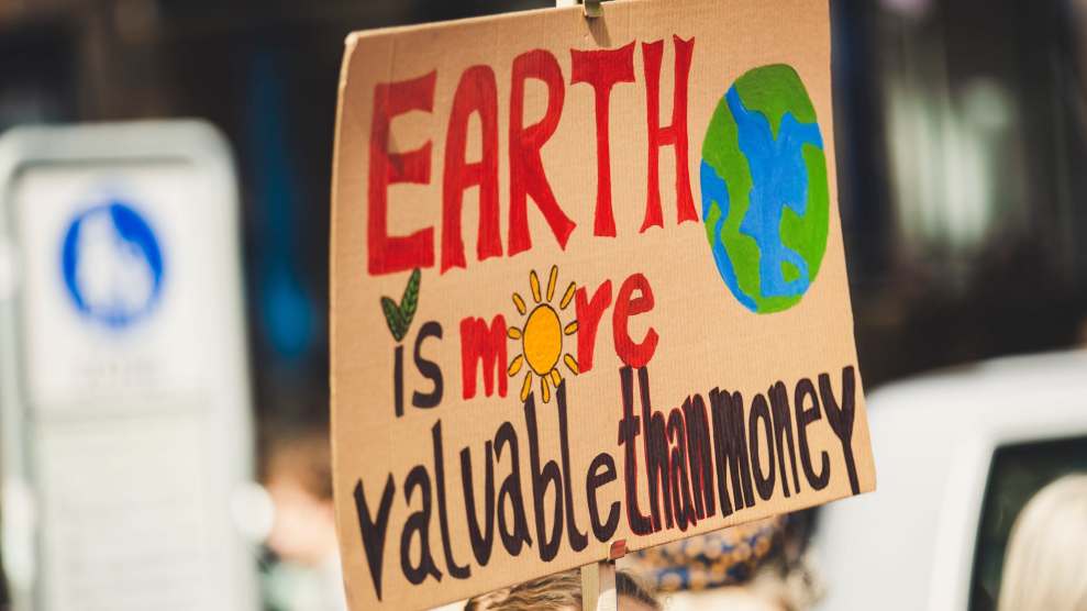 Protest sign that says "Earth is more valuable than money"