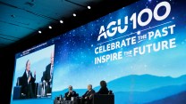 Three individuals sit on a stage. Behind them "AGU100 Celebrate Past Inspire Future" is projected behind them.