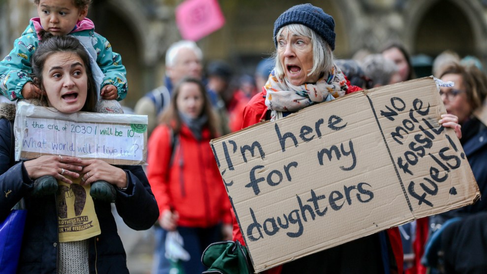 A climate protest with the main person in the image being an aging white woman with the sign "I'm here for my daughters, no more fossil fuels."