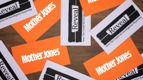 Mother Jones and Reveal business cards scattered on a tabletop.