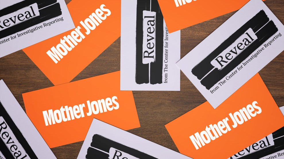 Mother Jones and Reveal business cards scattered on a tabletop.