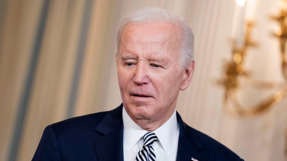 Joe Biden looking down while wearing a suit at a white house event