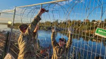 Texas Army National Guard soldiers attached razor wire to a temporary fence closing off access to the Rio Grande in Eagle Pass.