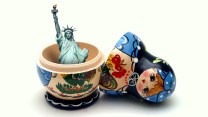 Photoillustration featuring an opened Russian matryoshka doll, revealing the Statue of Liberty inside.