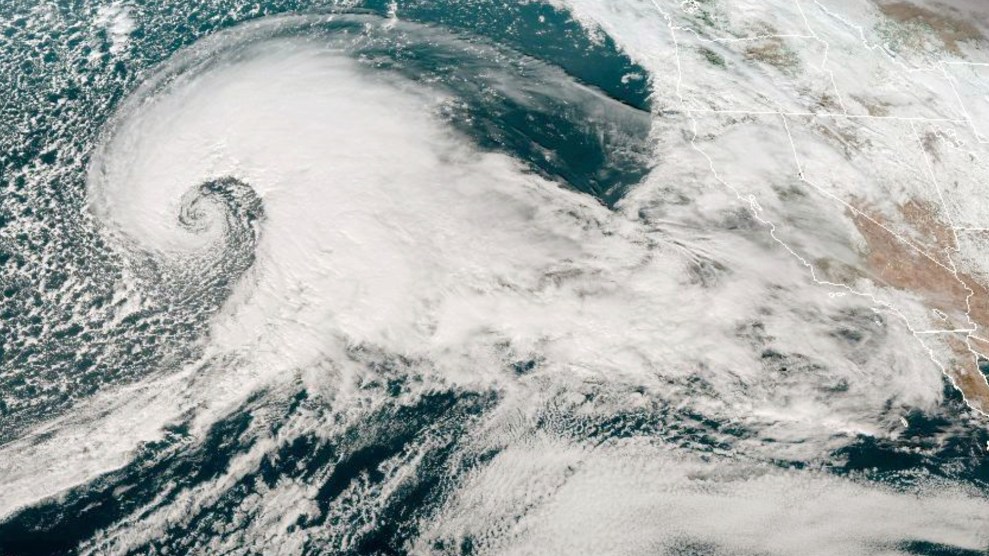 A spiraling white storm curls over California.