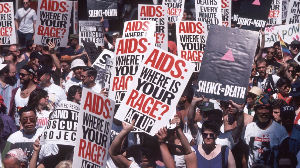 A large group of ACT UP activists holding signs that say AIDS: Where is your rage? and Silence = Death protesting at an LBGT parade in 1994.