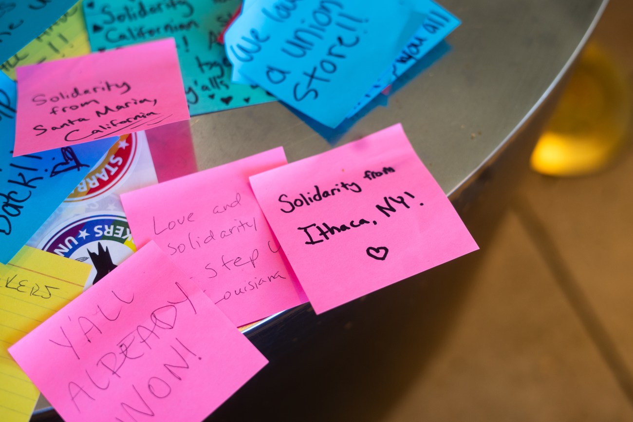 Close up of Post-It Notes, one reading "Solidarity for Ithaca, NY!"