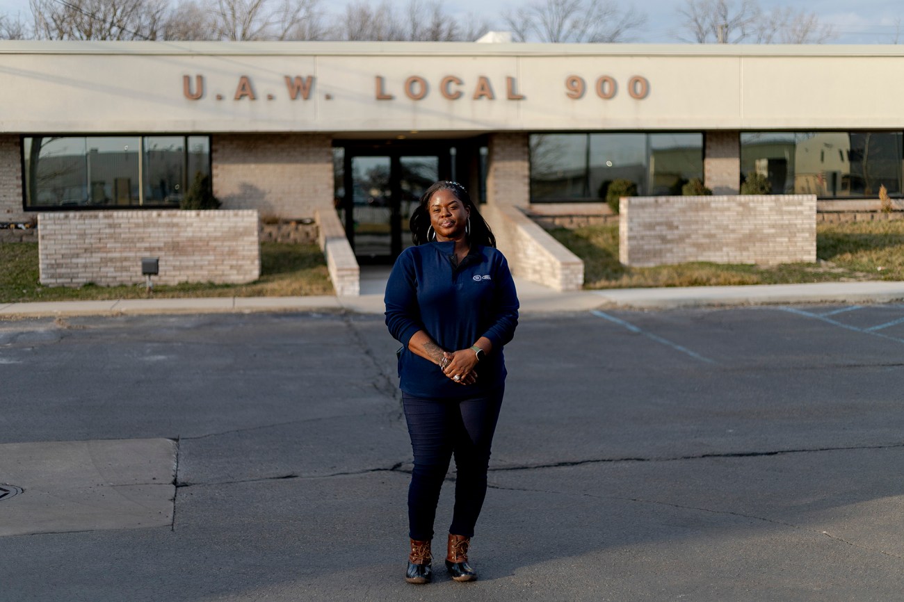 Woman standing in parking lot in front of UAW Local 900 building.