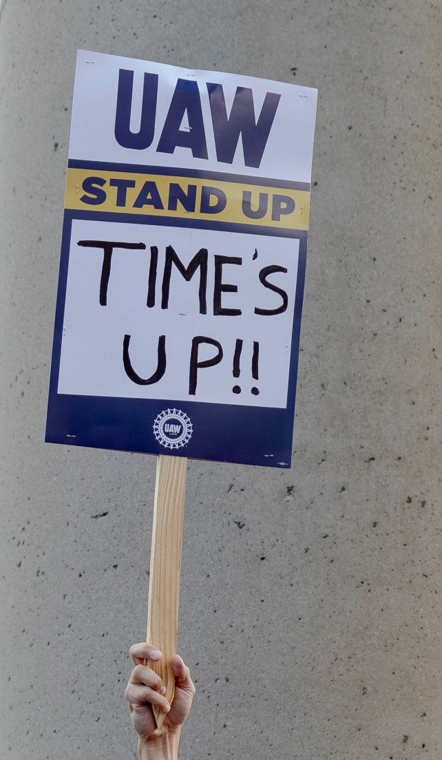 Close up of strike sign that reads, "UAW Stand Up: Time's Up!"