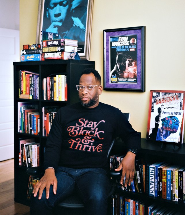 Portrait of a man sitting in front of bookshelves.