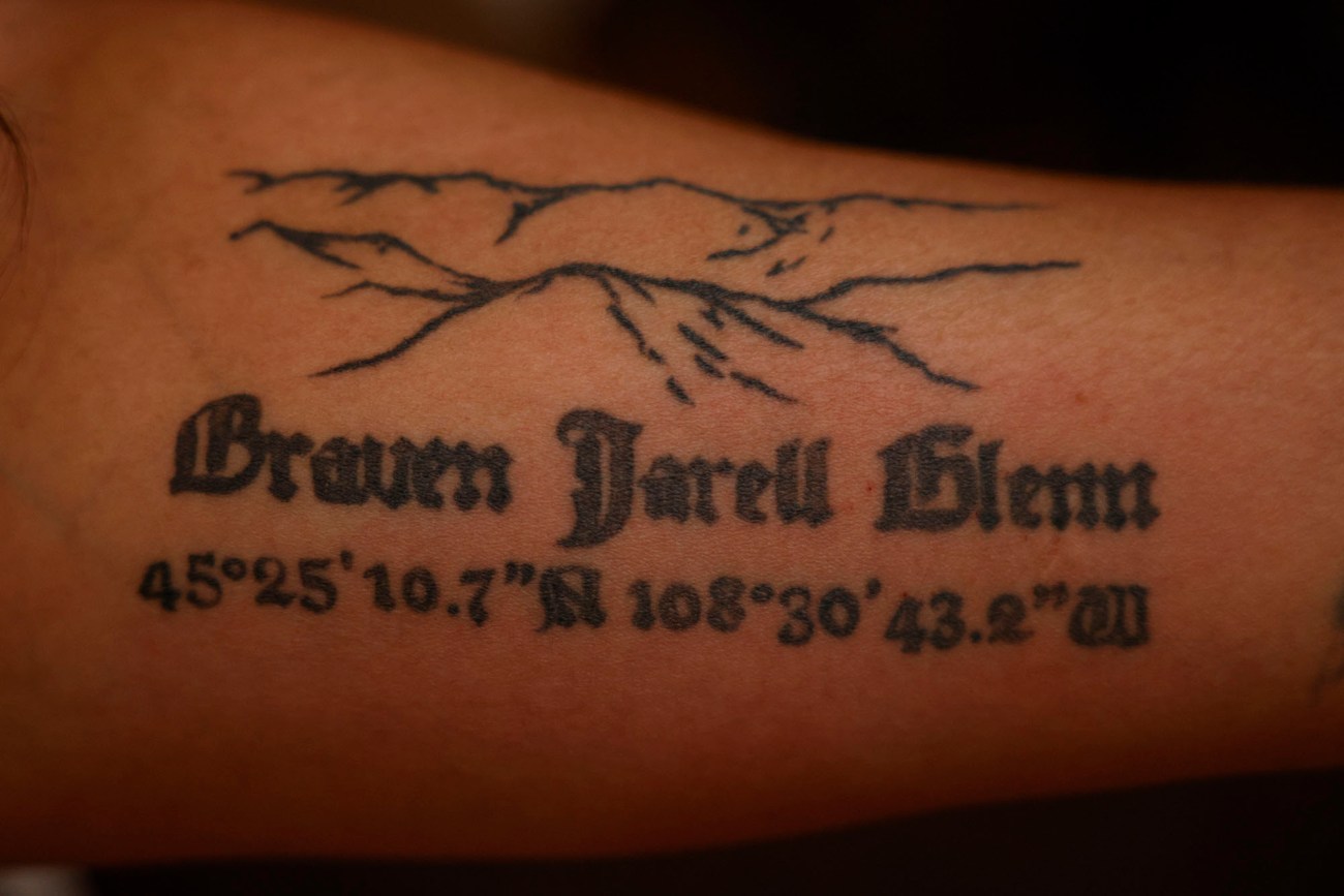 Tattoo of a mountain and the words "Braven Jarell Glenn."