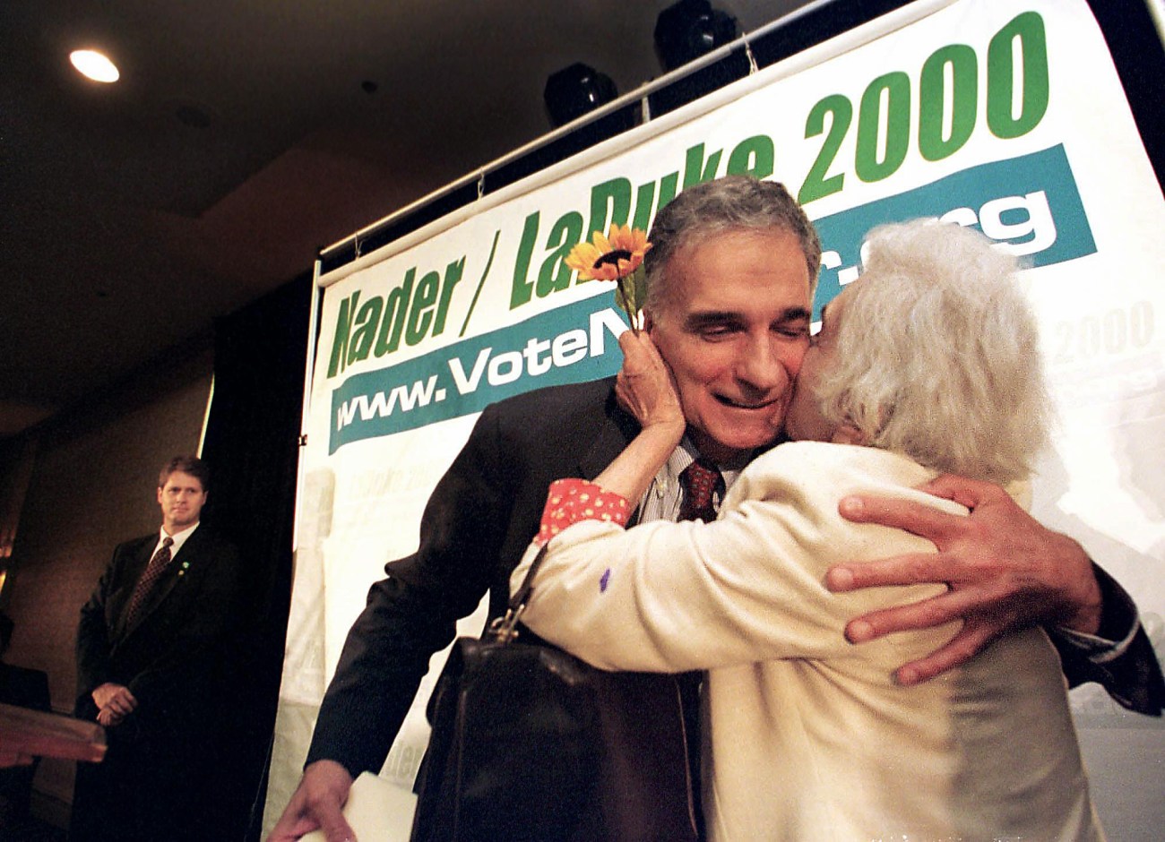 Ralph Nader leaning over, getting a kiss on his cheek from his mother.