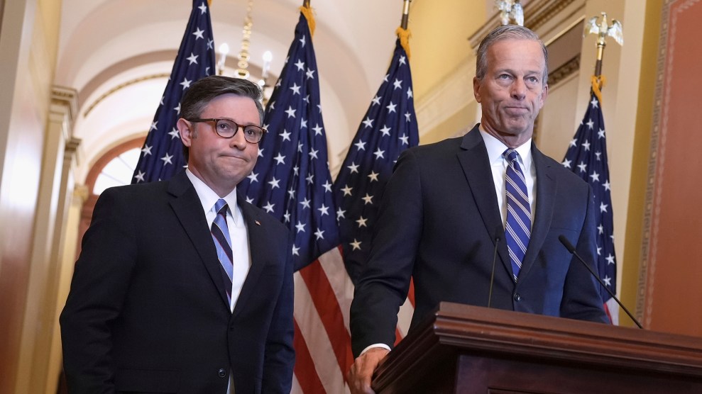 Two white men stand in front of a podium.