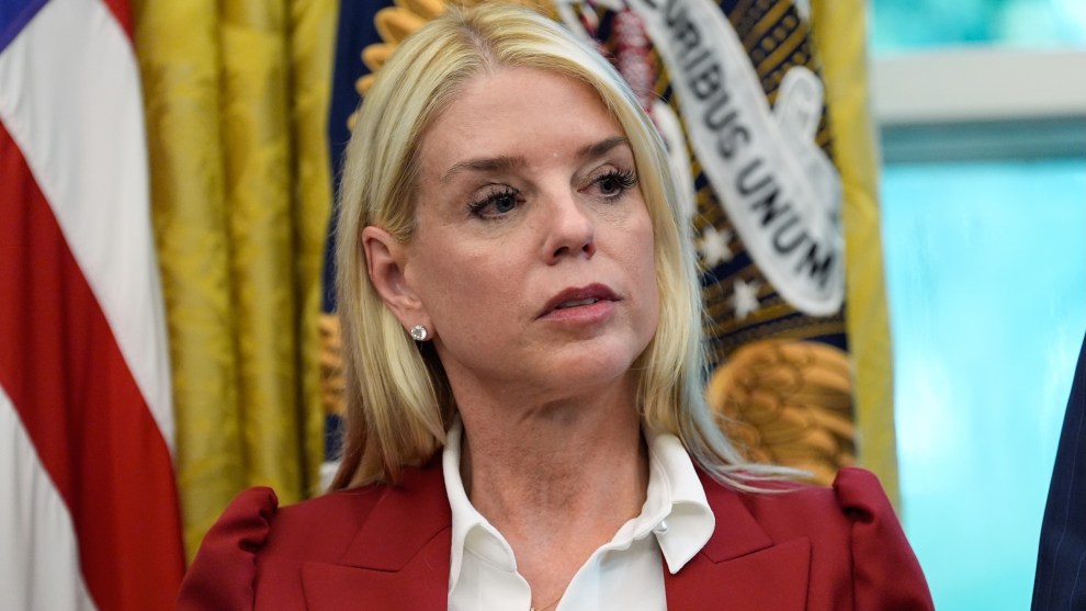 Attorney General Pam Bondi listens as President Donald Trump signs a presidential memorandum