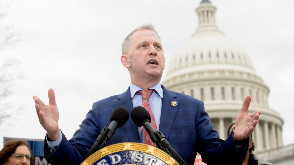 A white mean speaks at a podium