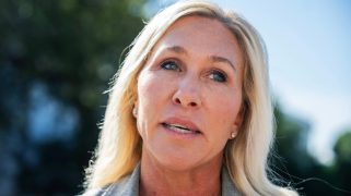 Rep. Marjorie Taylor Greene (R-Ga.) standing outside and looking off to the side while speaking.