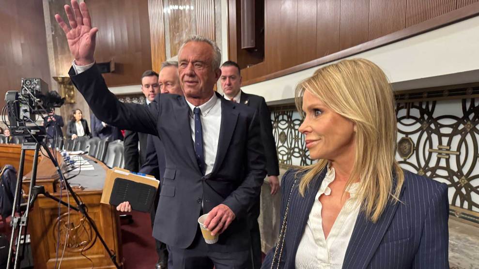 Robert F. Kennedy Jr. waving while standing next to his wife, Cheryl Hines