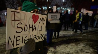 Community members and organizations associated with the Minnesota Free Palestine Coalition hold a rally in Minneapolis, Minnesota, on december 08, 2025, in response to recent federal rhetoric and policy actions affecting Somali and Afghan residents. A protestor holds a sign that says "I LOVE MY SOMALI NEIGHBORS."