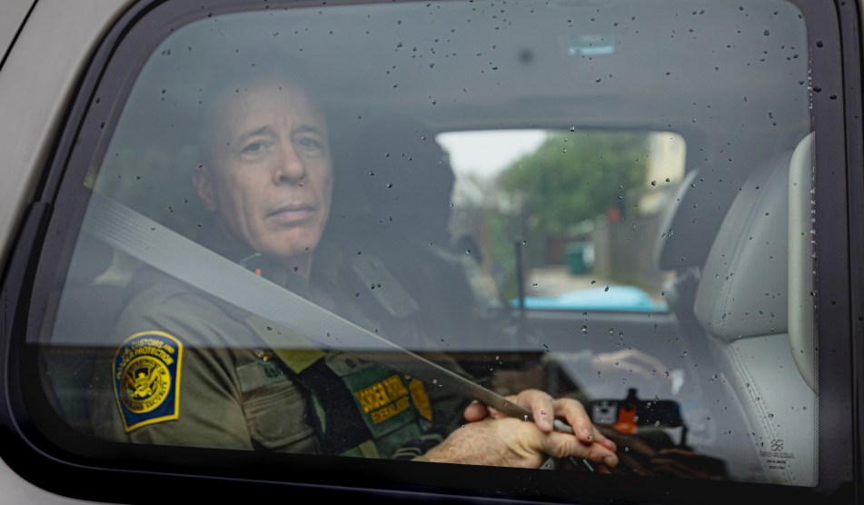 Bovino looks out toward a camera which is placed against a car window.