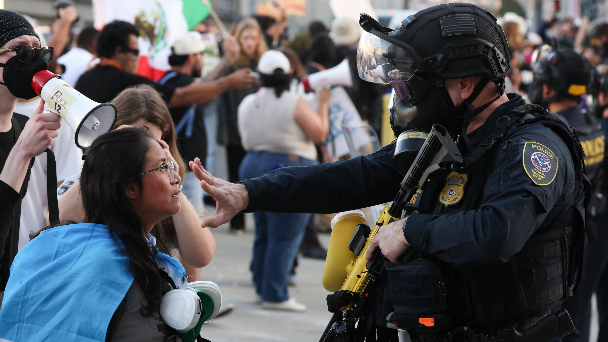 A law enforcement agent places his hand in front of a protestor's face during a "National Shutdown" protest against US Immigration and Customs Enforcement in Los Angeles on January 30, 2026. 