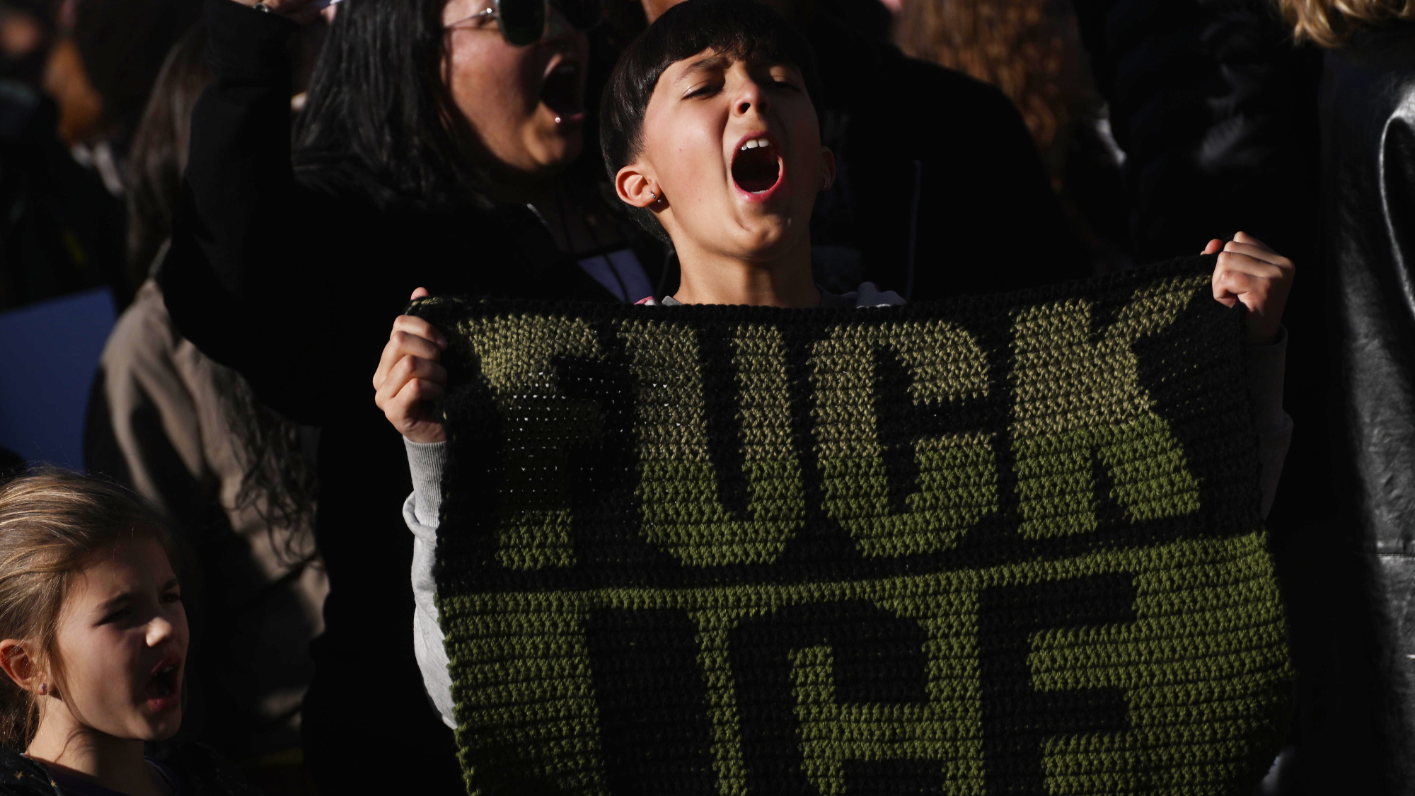 Darrell Gm, 11, screams while holding a blanket that states "FUCK ICE" while participating in a protest against ICE "reign of terror" actions ongoing in Minnesota on January 30, 2026 in Denver, Colorado. 