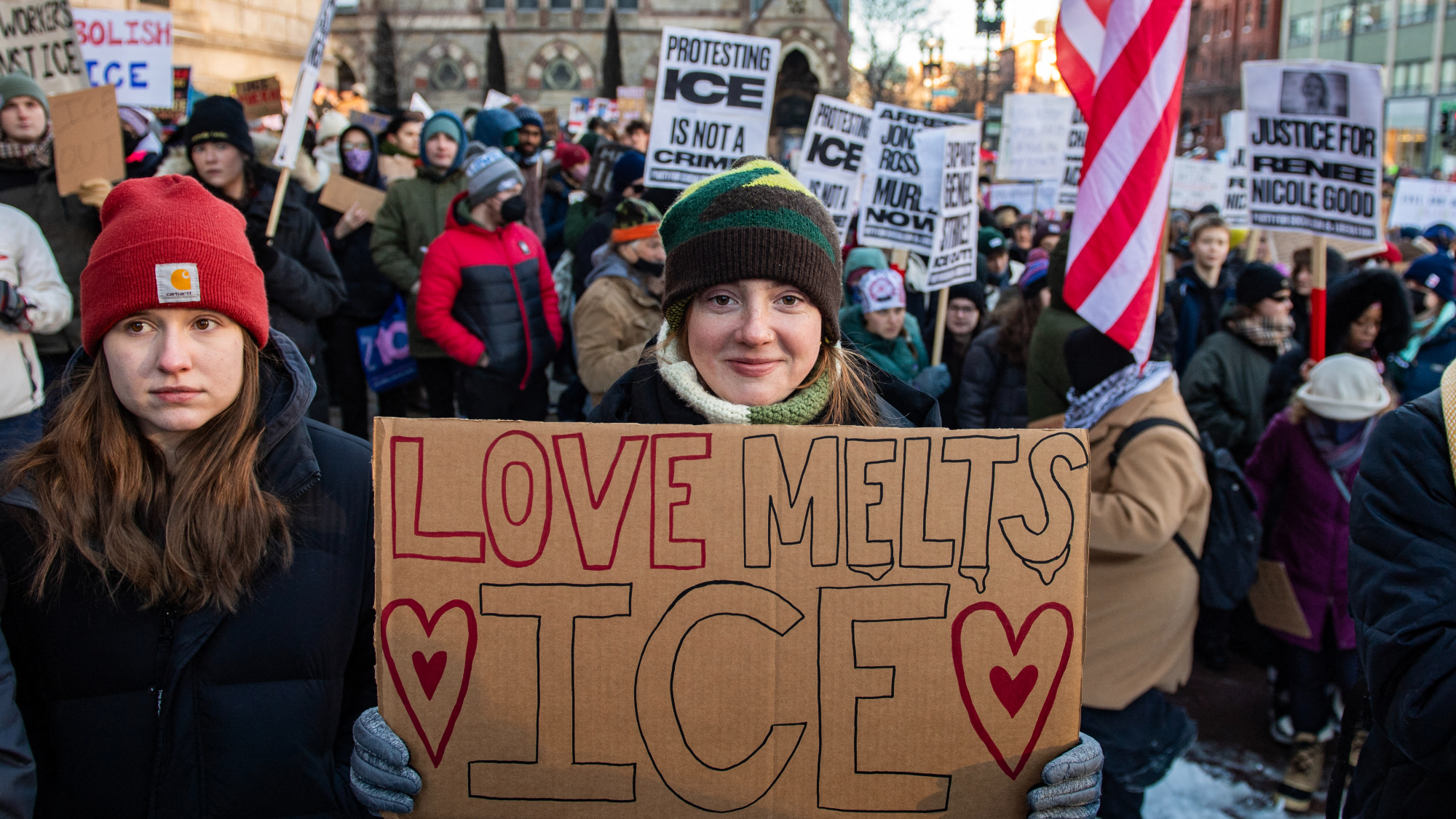 A woman holds a "Love Melts Ice" sign while people partake in a "National Shutdown" protest against U.S. Immigration and Customs Enforcement in Boston, Massachusetts on January 30, 2026. 