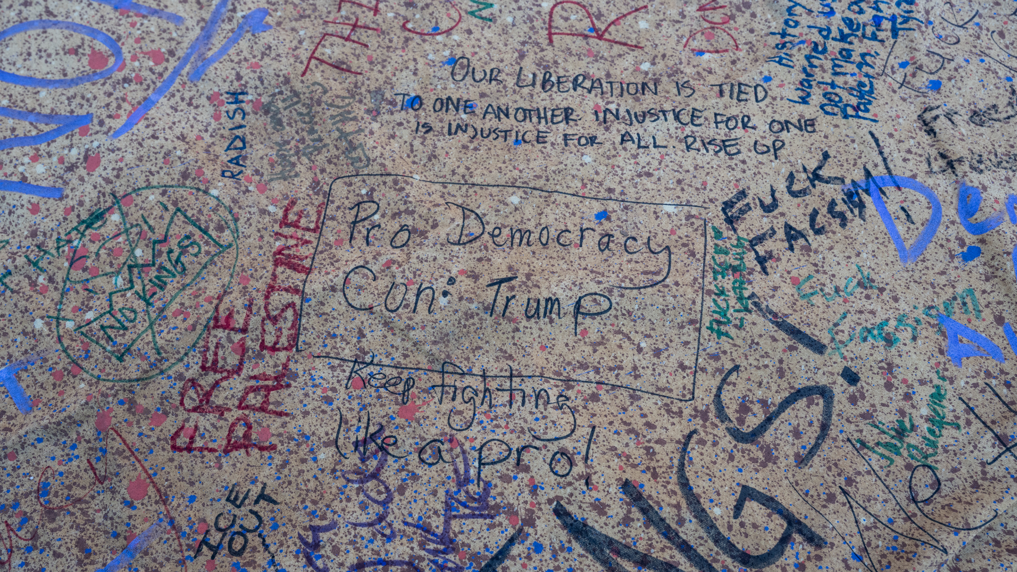 Messages written by protestors are seen on a giant canvas depicting the US Constitution at the end of a "National Shutdown" protest.