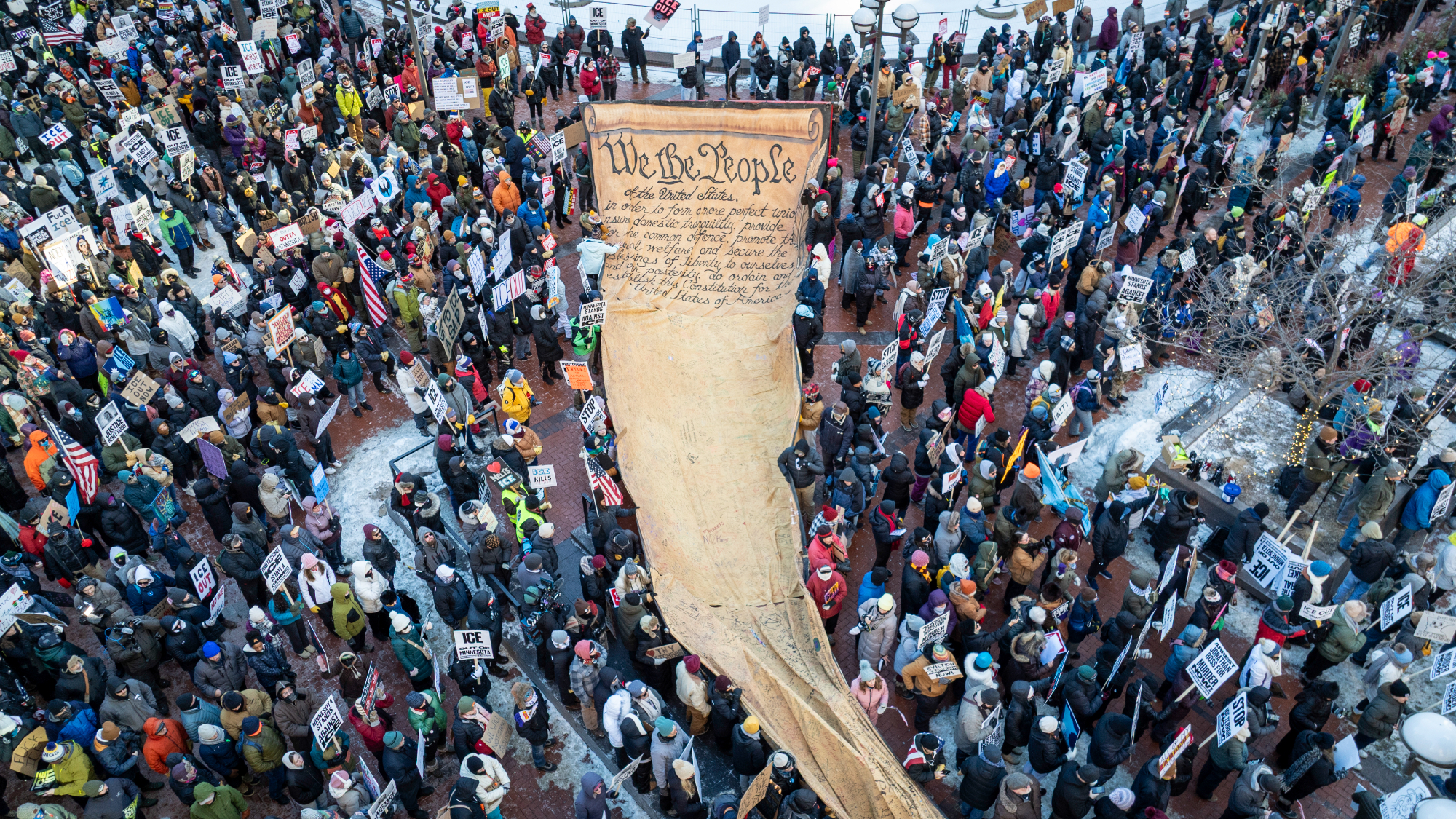 In an aerial view, demonstrators gather to march calling for an end to ICE operations in Minnesota.