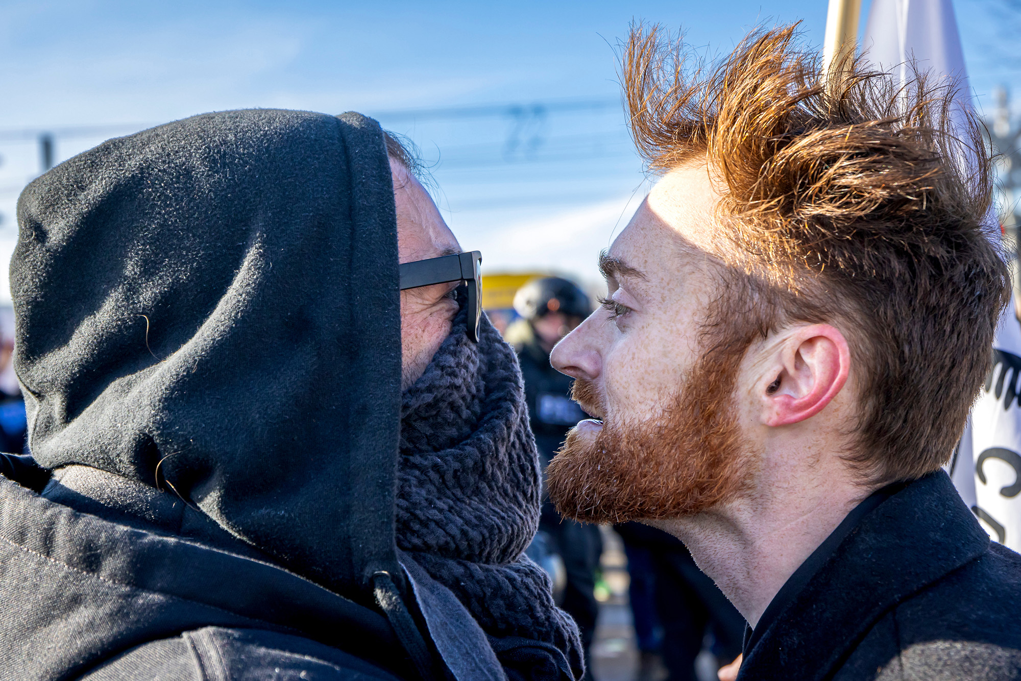 Two men, face-to-face, staring at each other.