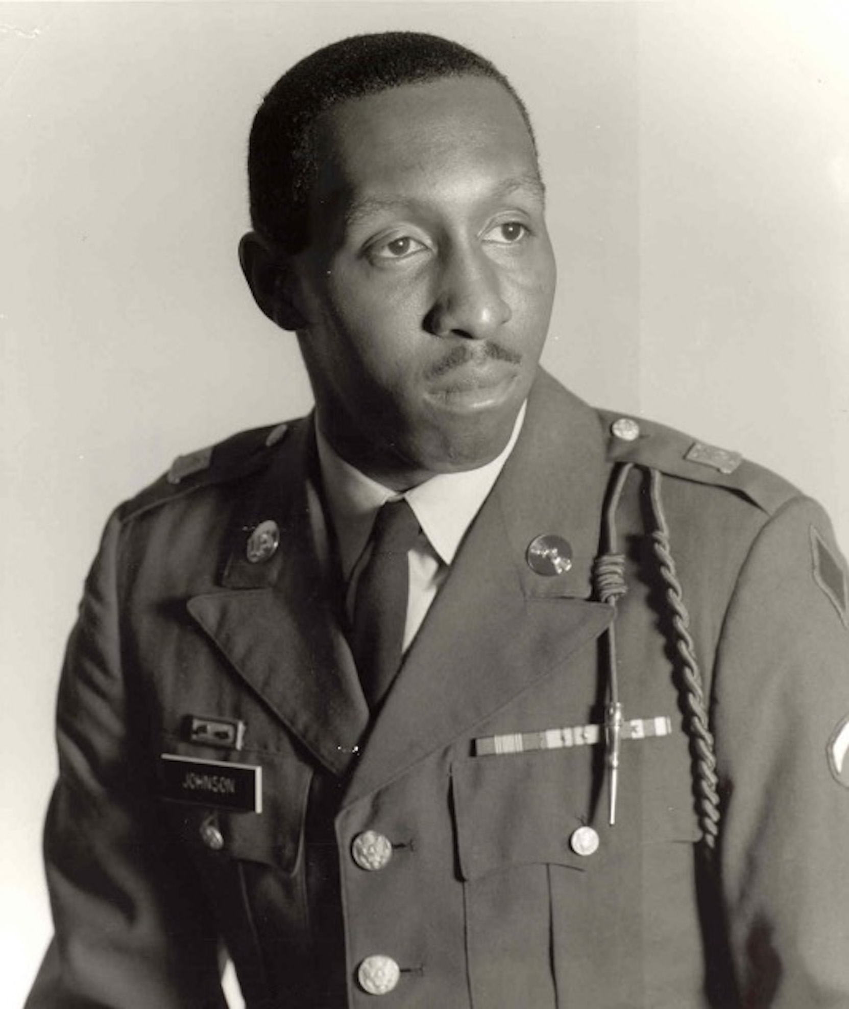 African American man in an official portrait, wearing an Army dress uniform.
