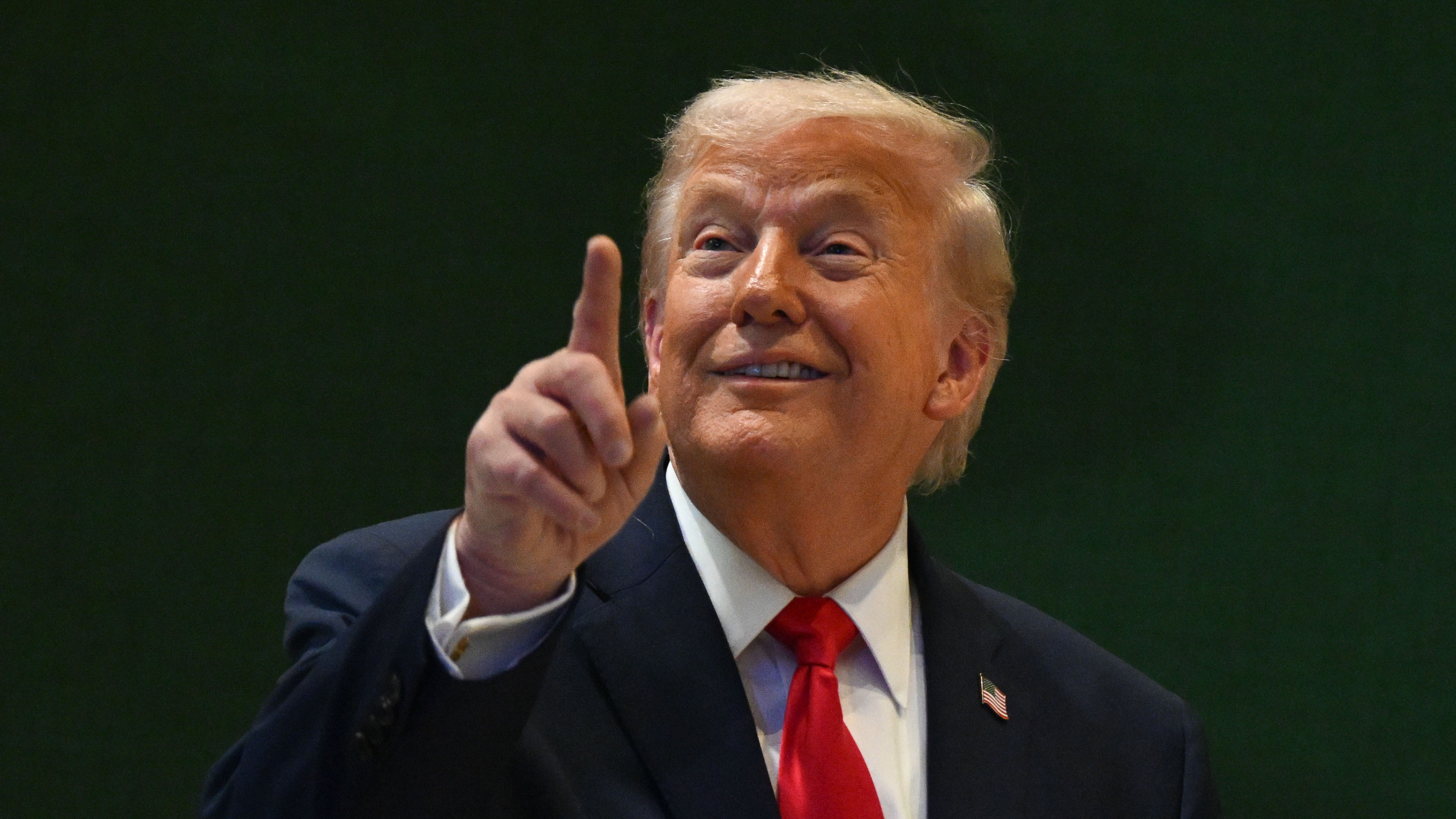 Donald Trump pointing as he speaks.