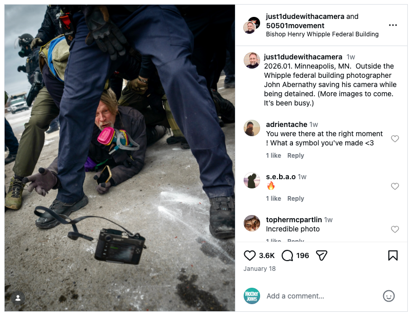 Instagram embed of photojournalist on the ground, throwing his camera to another photographer.
